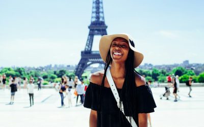 woman standing behind Eiffel Tower during daytime